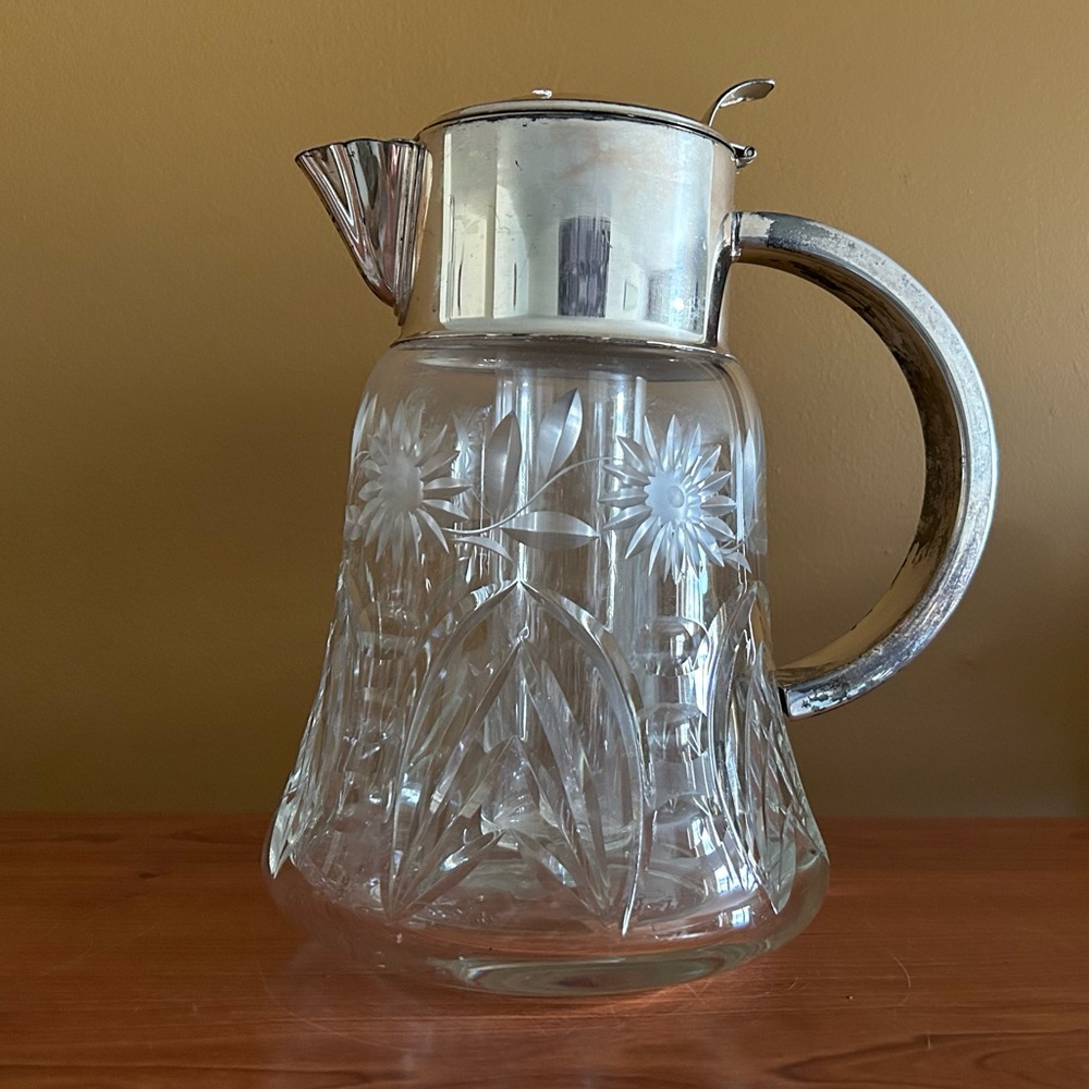 Heavy glass floral etched pitcher with silver plate lid and ice chamber
